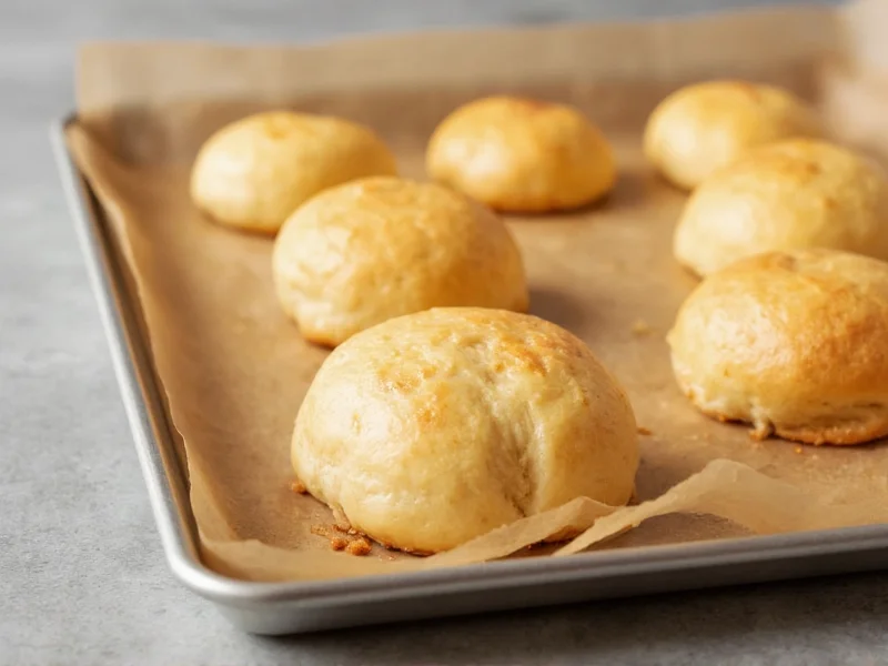 Golden yeast-free rolls on baking sheet
