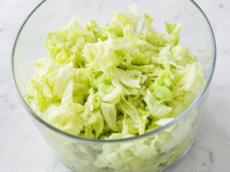 Fresh green cabbage shreds in glass bowl ready for fermentation