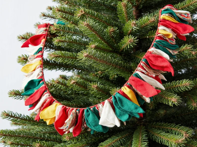 Colorful fabric scrap garland on minimalist Christmas tree