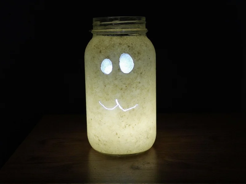 Recycled glass jar ghost lantern with glowing eyes