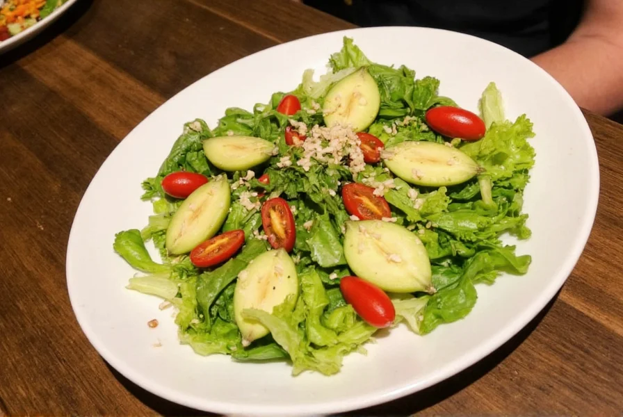 Fresh ginger salad ingredients including young ginger root, mixed greens, sesame seeds, and citrus fruits arranged on wooden cutting board