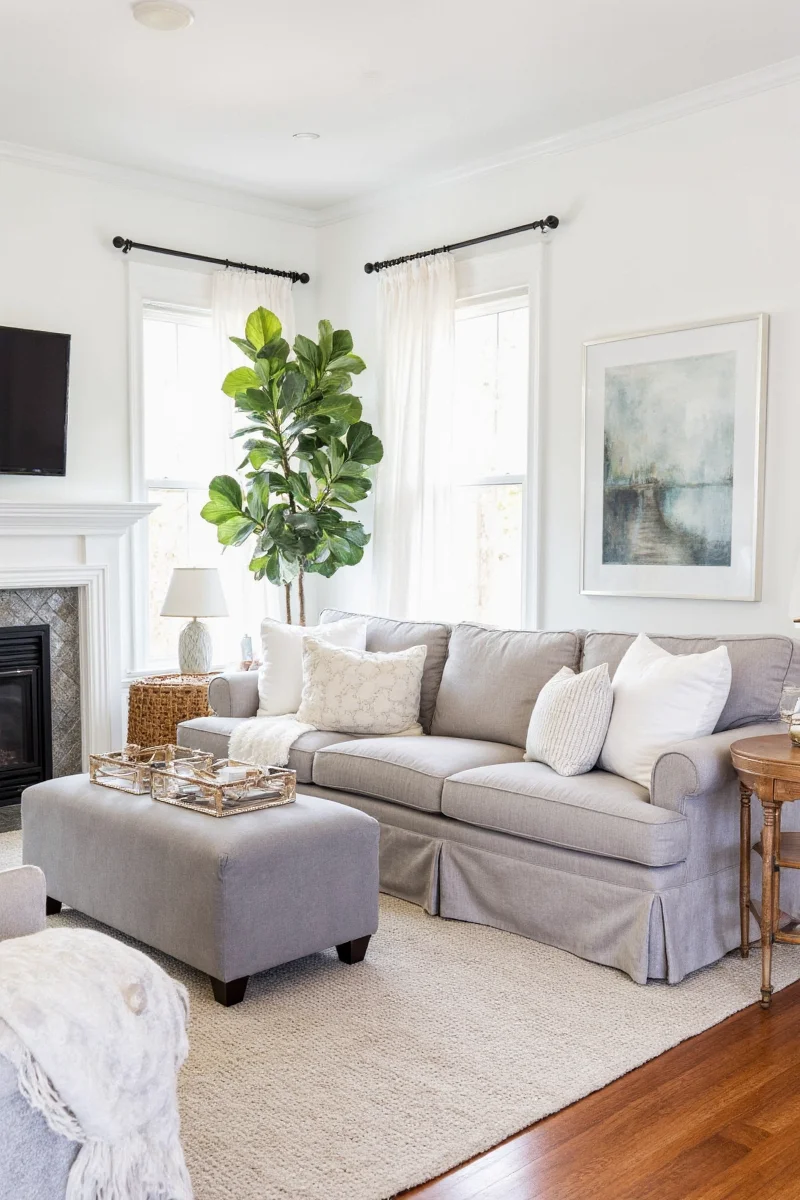 Framed photos above a white sofa