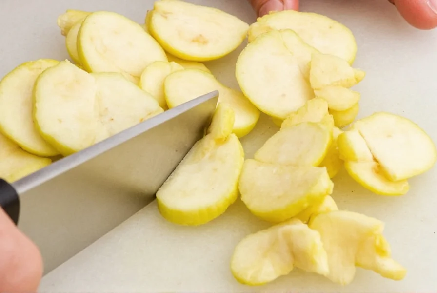 Close-up of knife slicing ginger crosswise against the grain showing proper hand position