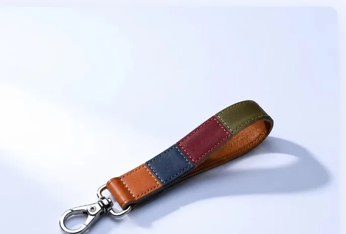 Multicolor patchwork leather wrist strap keychain, centered studio detail