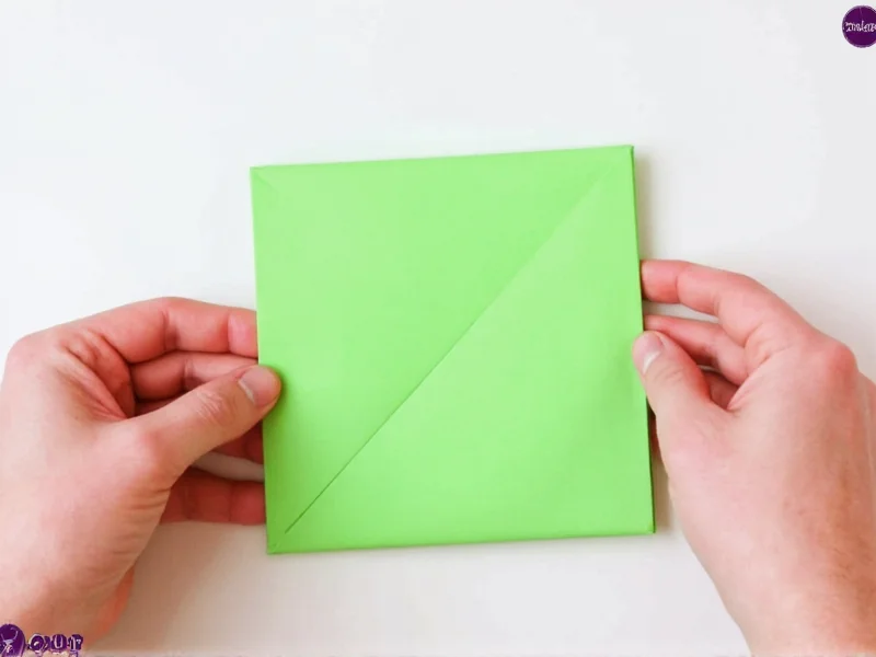 Origami backpack folding step 1: creasing square paper diagonally