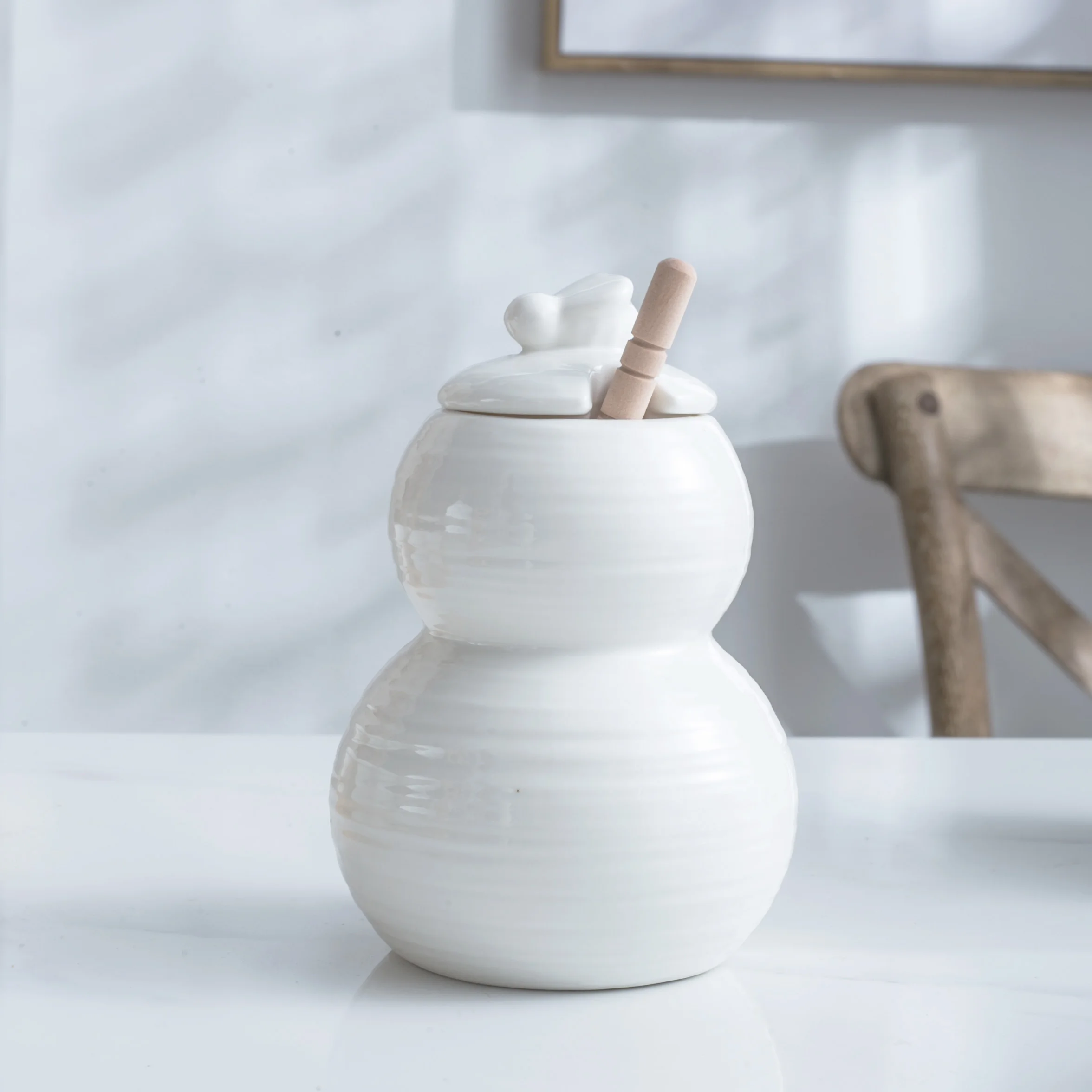 

White honey bee bottles with spoon ceramic honey jars