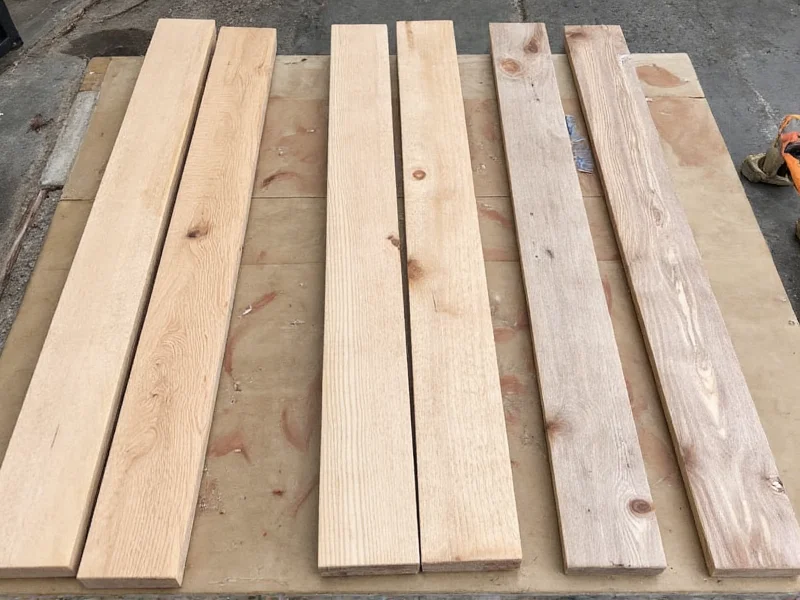 Reclaimed wood materials laid out for DIY clothes rack project