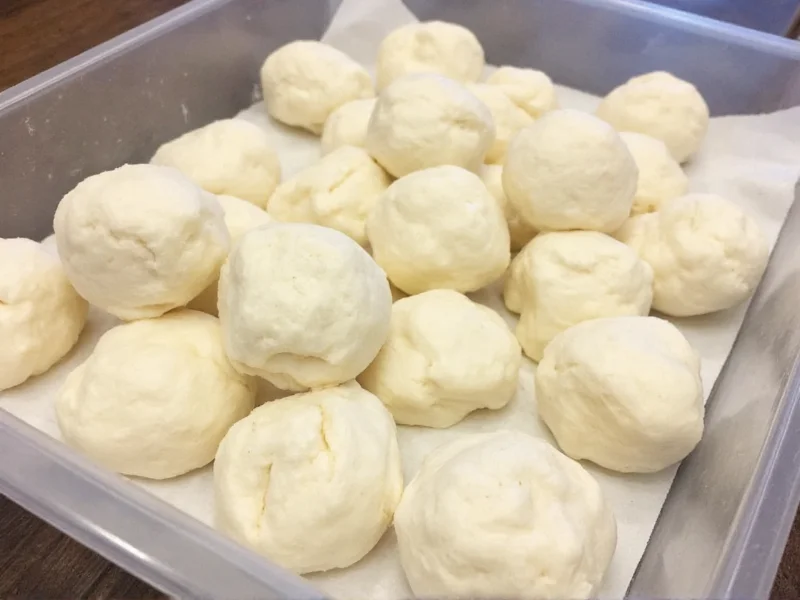 Frozen quick pizza dough balls in container