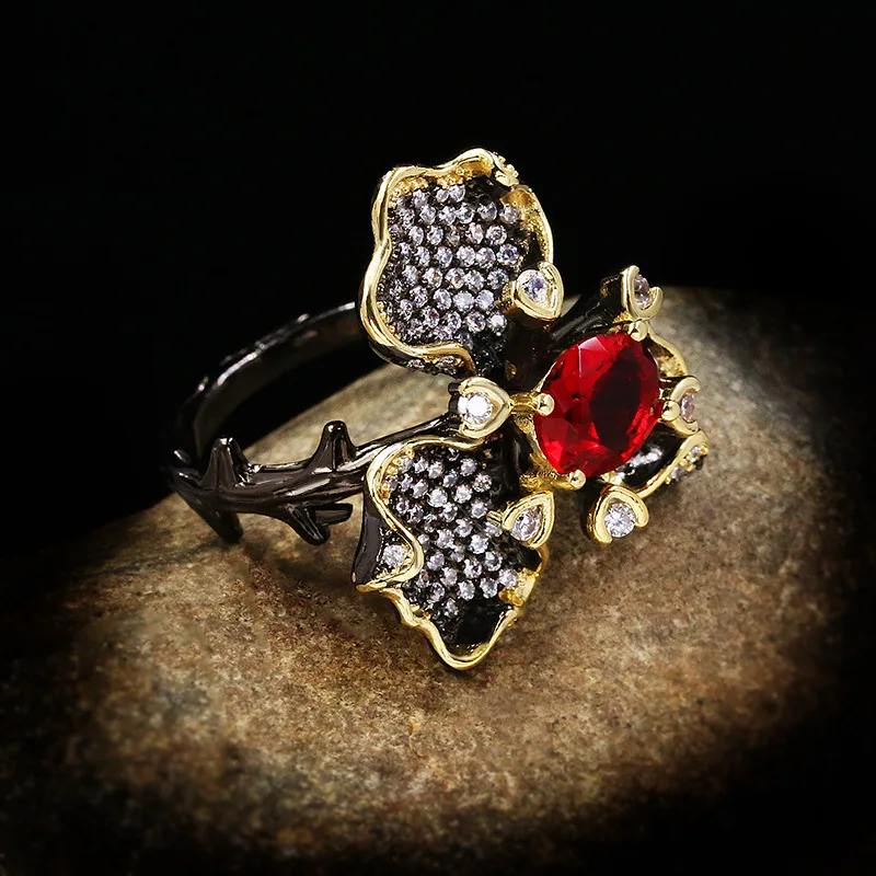 

Europe and America hot selling jewelry black gold flower inlaid red diamond women exaggerated ring wholesale