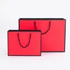 Factory direct supply OEM custom logo luxury red paper shopping wedding gifts bags with colored ribbon handle in black border