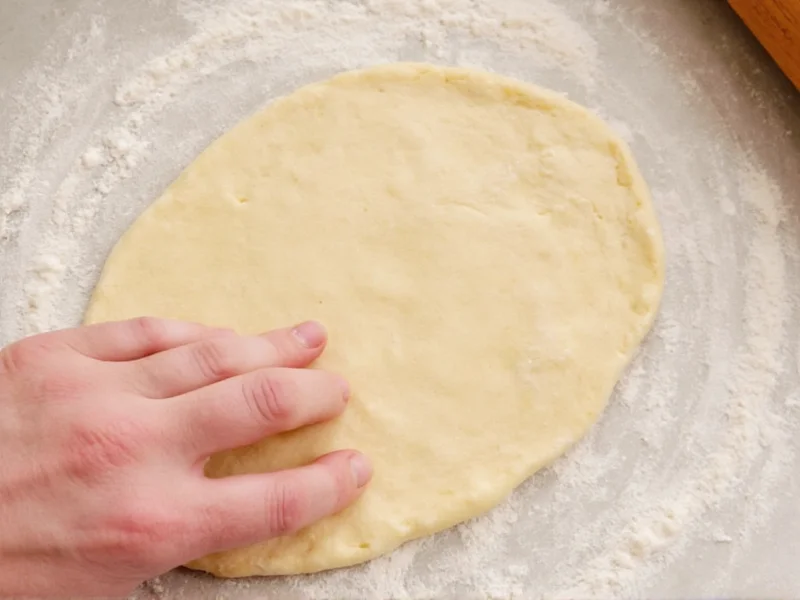 Hand shaping donut dough circles on floured surface
