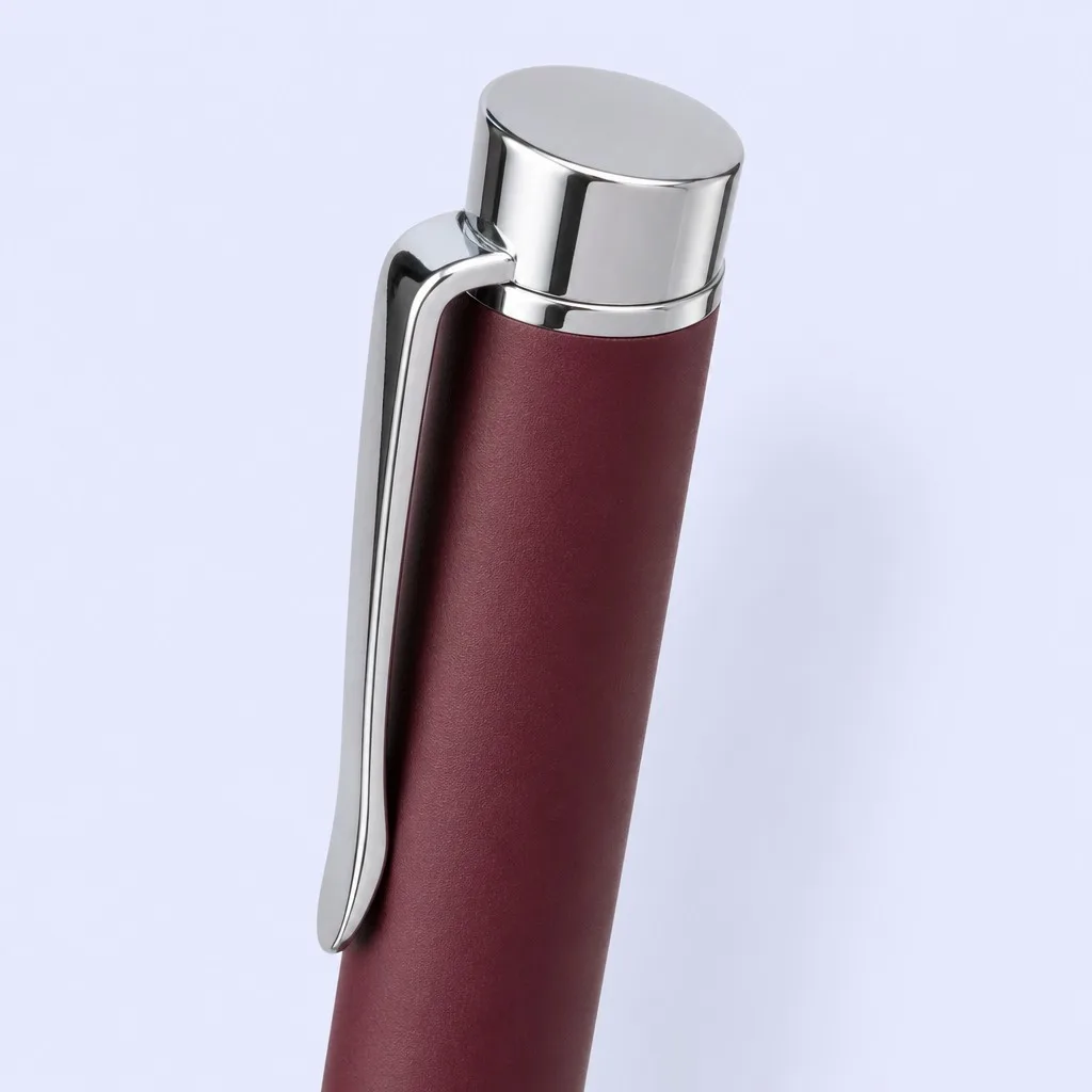 Close-up of a burgundy pen cap with polished silver clip