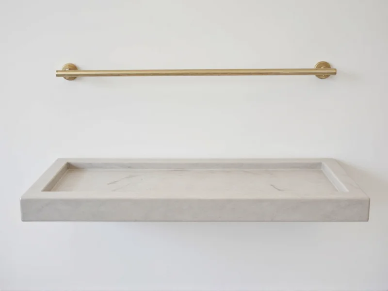 Minimalist floating bar mounted to wall with brass hardware