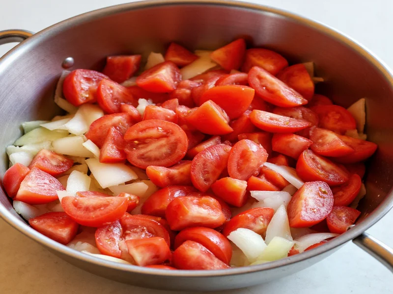 Fresh diced tomatoes and onions in mixing bowl