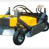 The garden mower is attached to a small machine