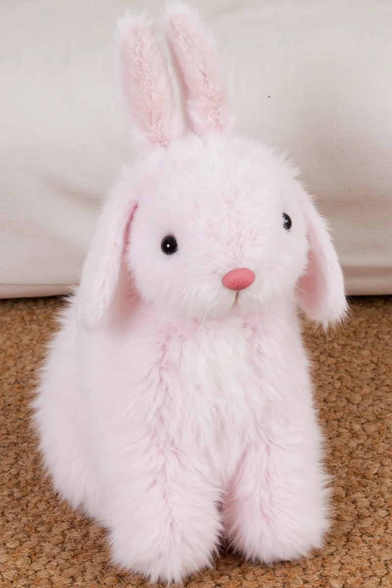 Gallery wall featuring various styles of bunny-themed art framed in white and light wood