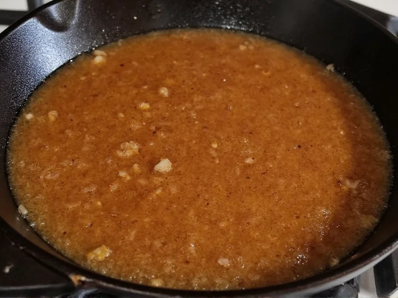 Homemade au jus simmering in cast iron skillet
