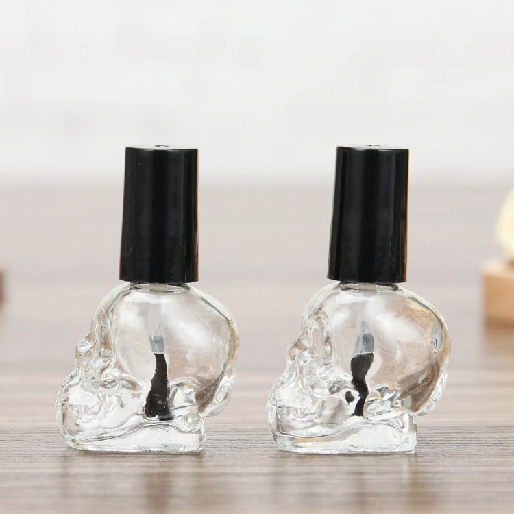 

Luxury empty skull shape 10ml glass nail polish bottles clear nail polish bottle packaging with brush