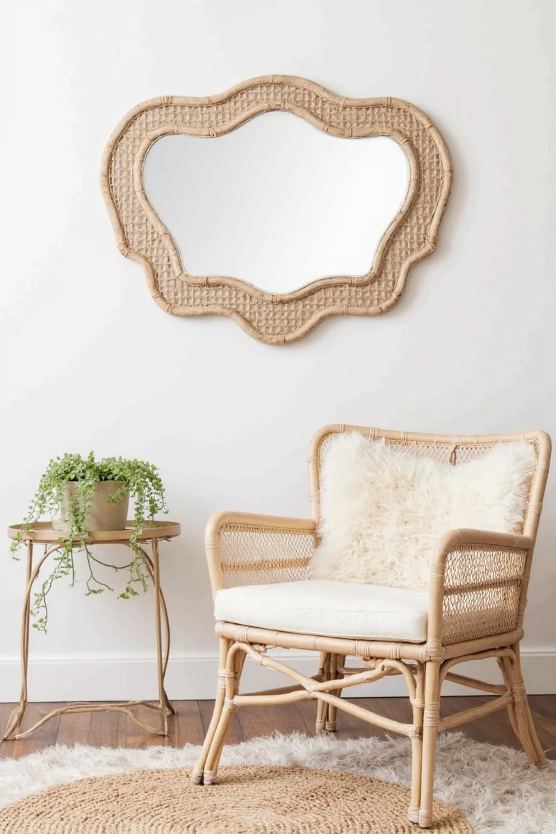 Stylish hallway with rattan mirror, coat rack, and plants