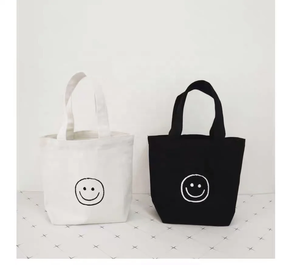 

2020 new mini cotton shopping bag of cute smiling face lunch canvas bag cosmetic Bag, White, black or customized