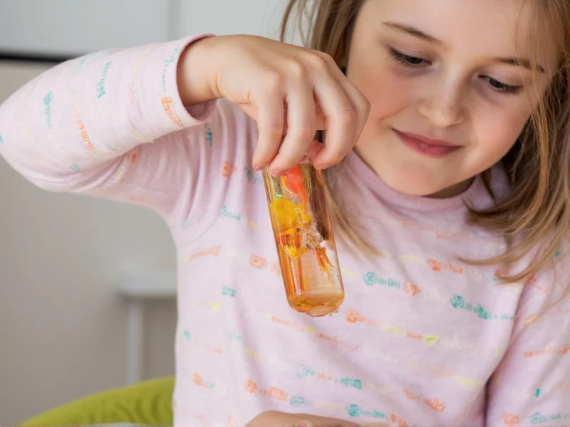 Child using sensory bottle during therapy session