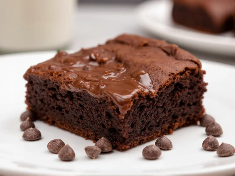 Slice of dense homemade brownie with melted chocolate chips