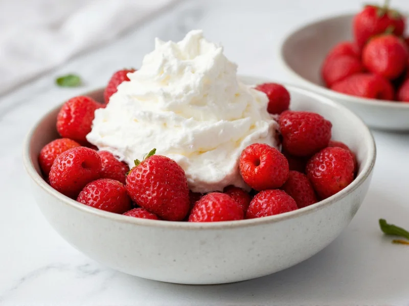 Fresh homemade whipped cream dolloped on berries