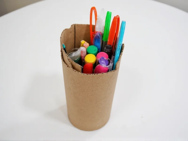 Handmade cardboard tube organizer holding colorful craft supplies