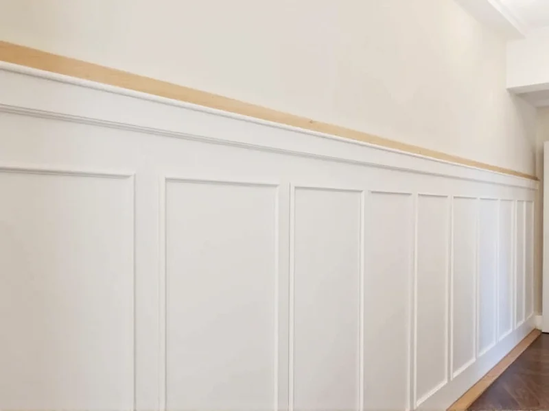 DIY wainscoting installation on living room wall