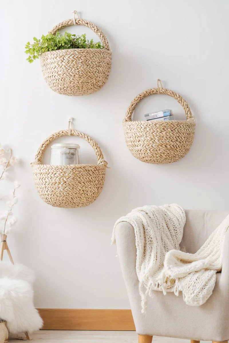 A cozy living room with hanging baskets holding books and stuffed animals