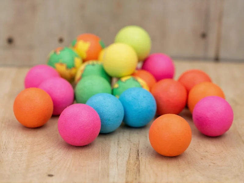 Painted foam craft balls on wooden surface