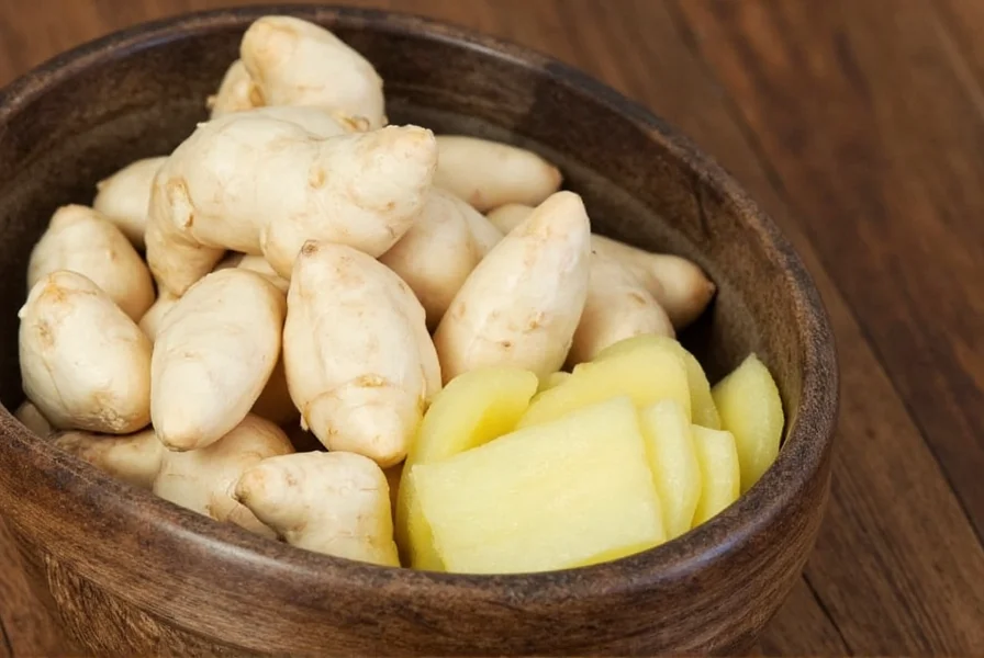White ginger plant growing in tropical garden showing distinctive pinecone-shaped inflorescences and leaf structure