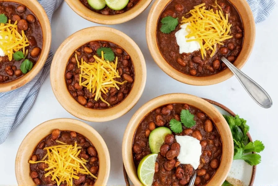 Finished crockpot chili served in bowls with various toppings including cheese, sour cream, and cilantro