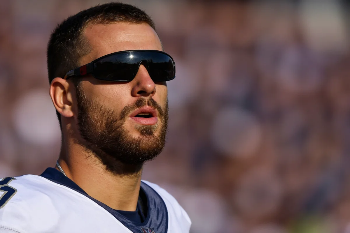 why do football players wear black under their eyes