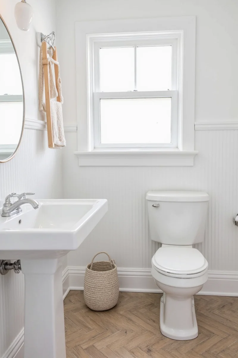 Bathroom with beadboard wainscoting and floral wallpaper