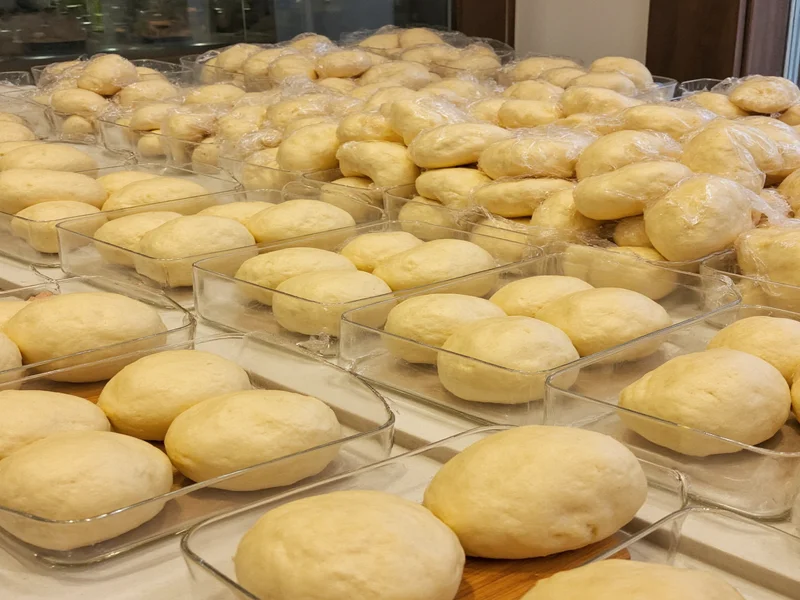 Pizza dough balls stored in glass containers