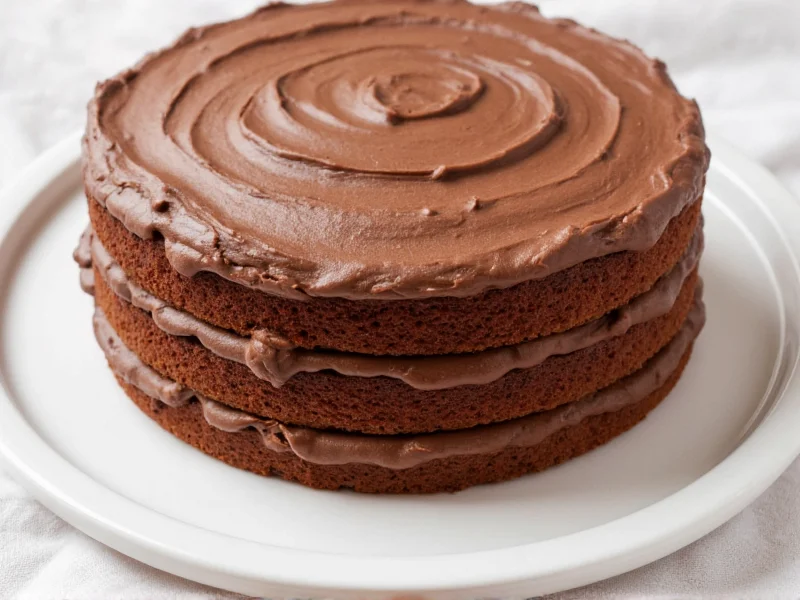 Homemade chocolate frosting on layered cake
