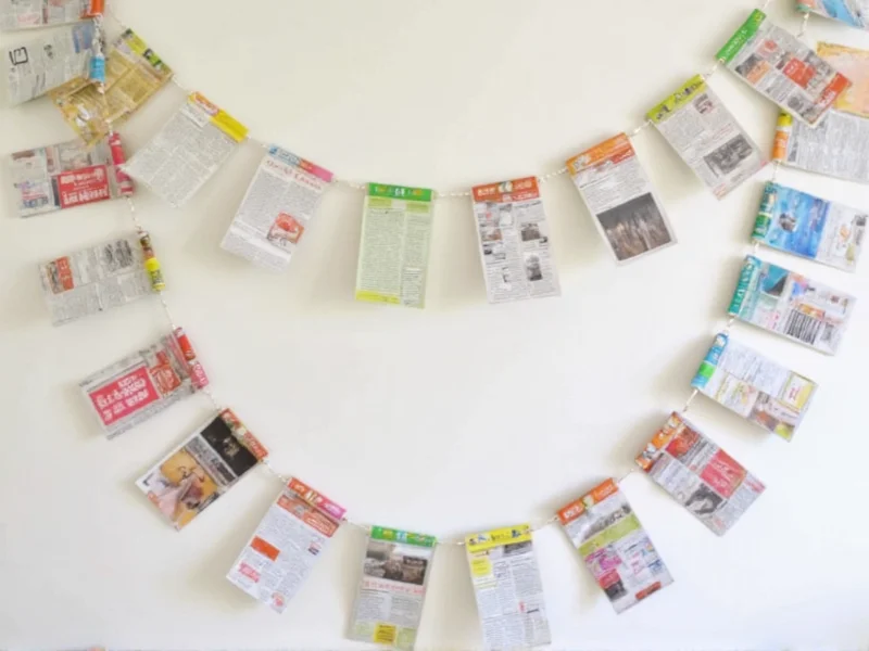 Colorful paper garland made from recycled magazine pages