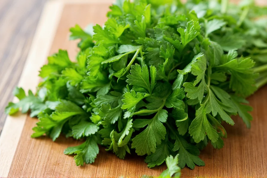 Fresh bunch of curly-leaf parsley with vibrant green leaves on wooden cutting board