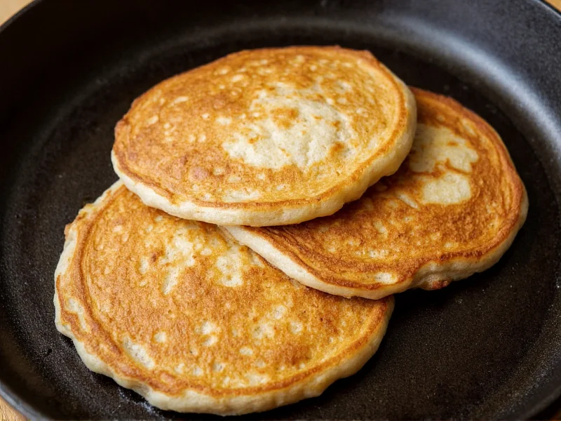 Fluffy banana pancakes on cast iron griddle