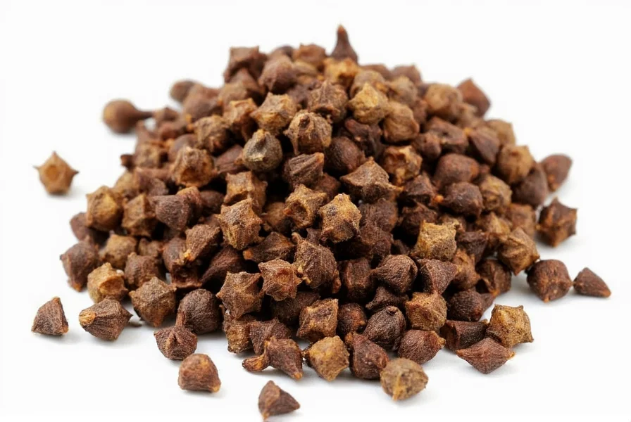 Whole cloves and ground cloves displayed side by side for comparison