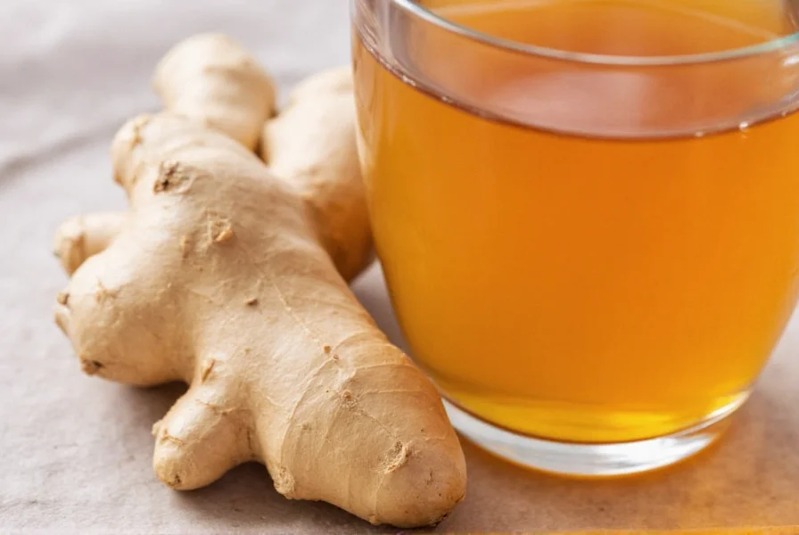 cup of ginger tea with fresh ginger slices on a wooden table