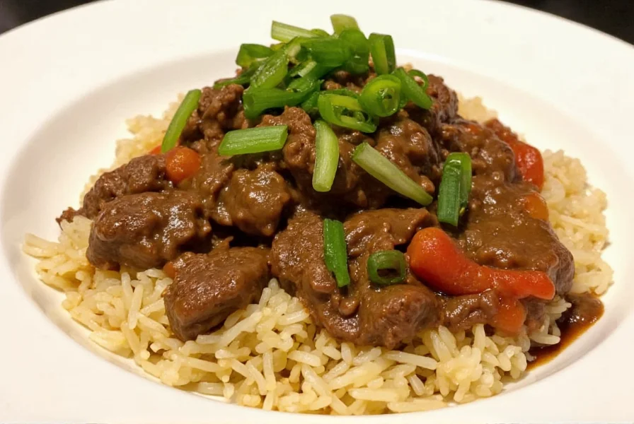 Finished slow cooker pepper steak served over rice with green onions