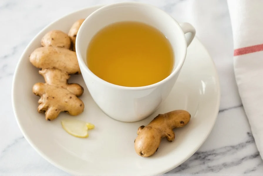 Fresh ginger root sliced and steeping in clear glass teapot with steam rising