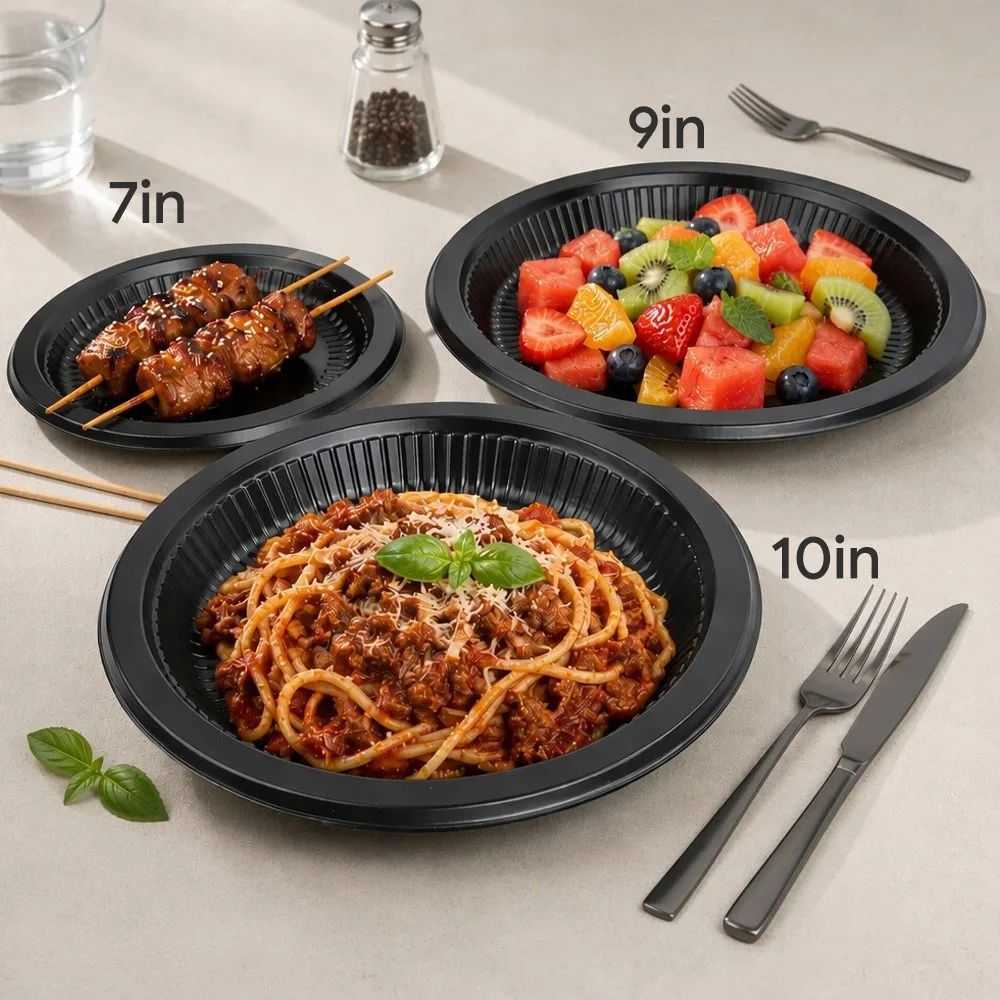 7-inch, 9-inch, and 10-inch black PP plates side by side plated with skewers, fruit salad, and spaghetti bolognese