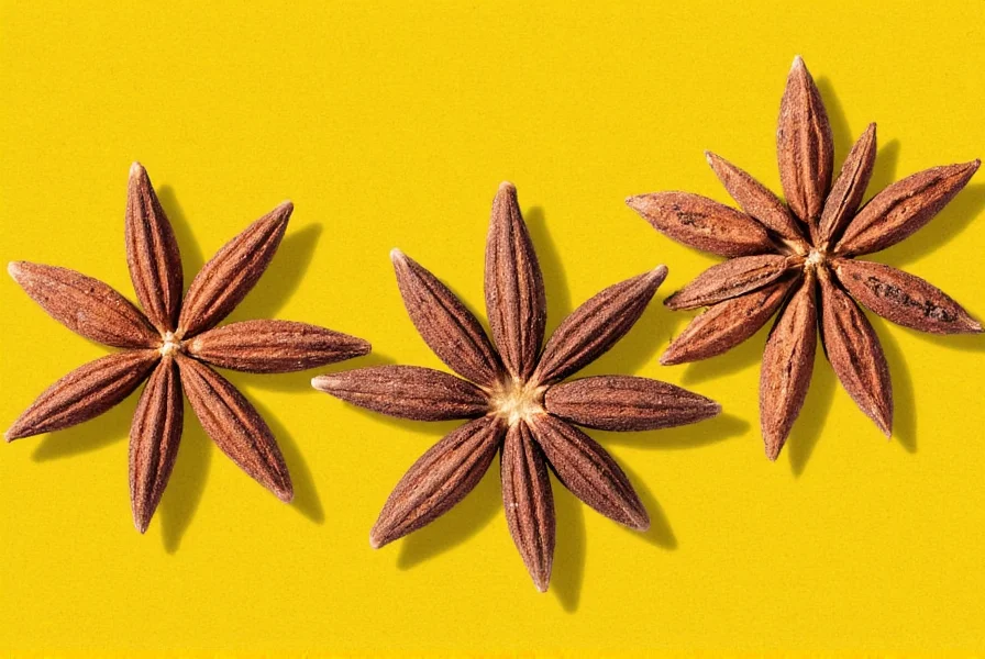 Spices including cloves on a wooden tray