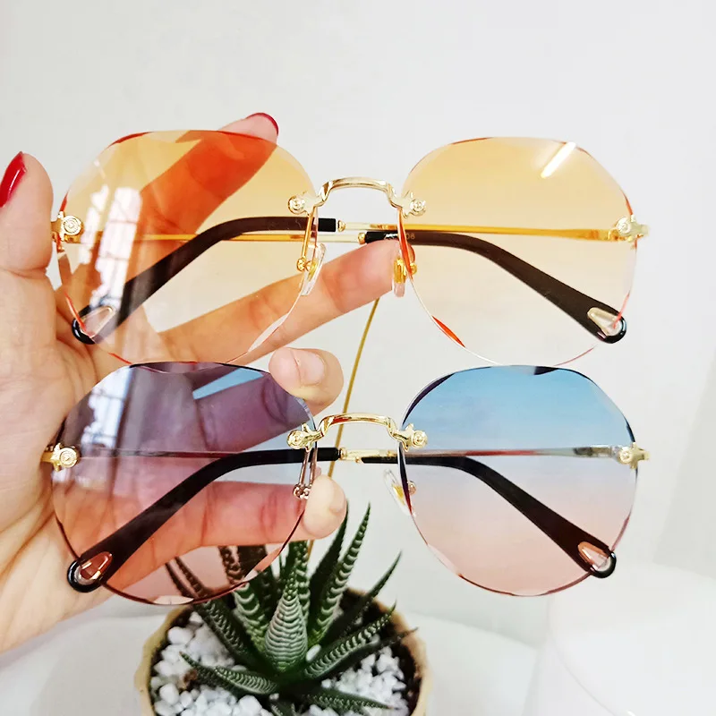 

Lmamba Wholesale 2022 Luxury Cut Edge Sunglasses Ladies Women New Fashionable Ocean Lens Vintage Rimless Sunglasses