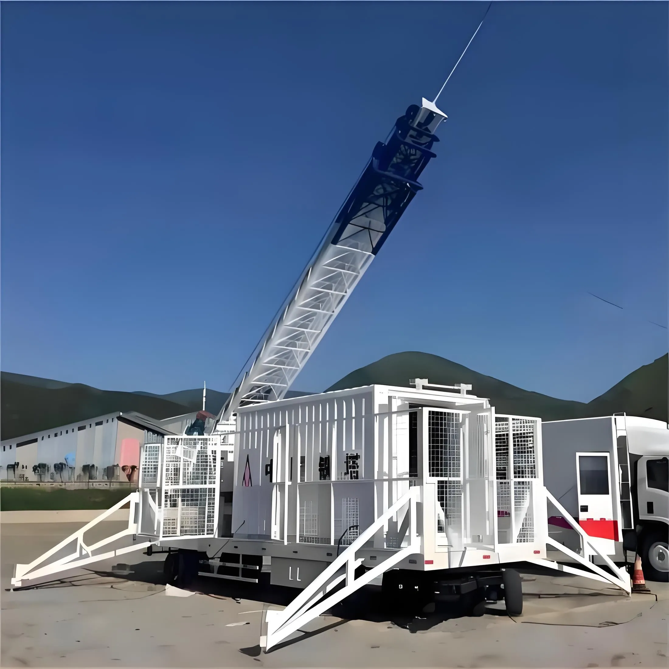 White trailer mounted lattice tower with deployed support legs
