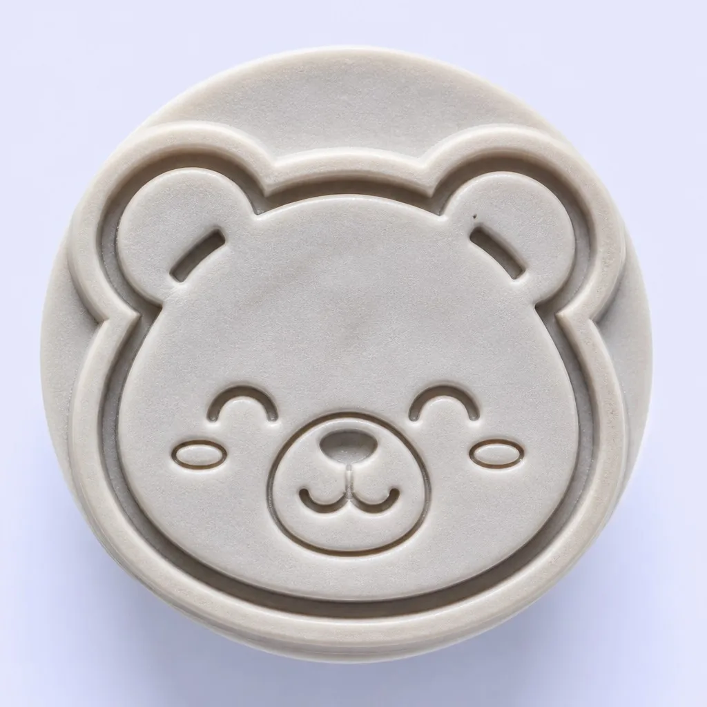 Close-up of an engraved rubber stamp with a cartoon face pattern
