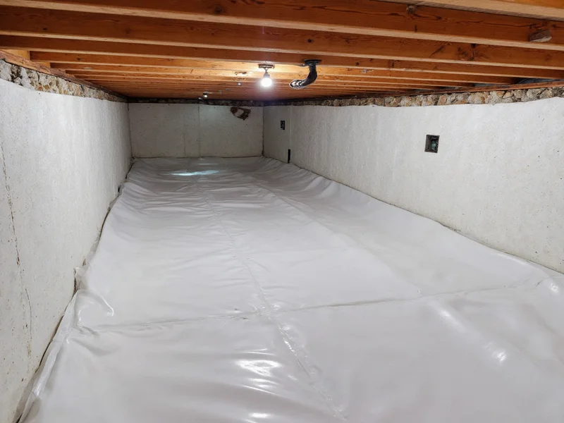 Completed DIY crawl space encapsulation showing sealed vapor barrier